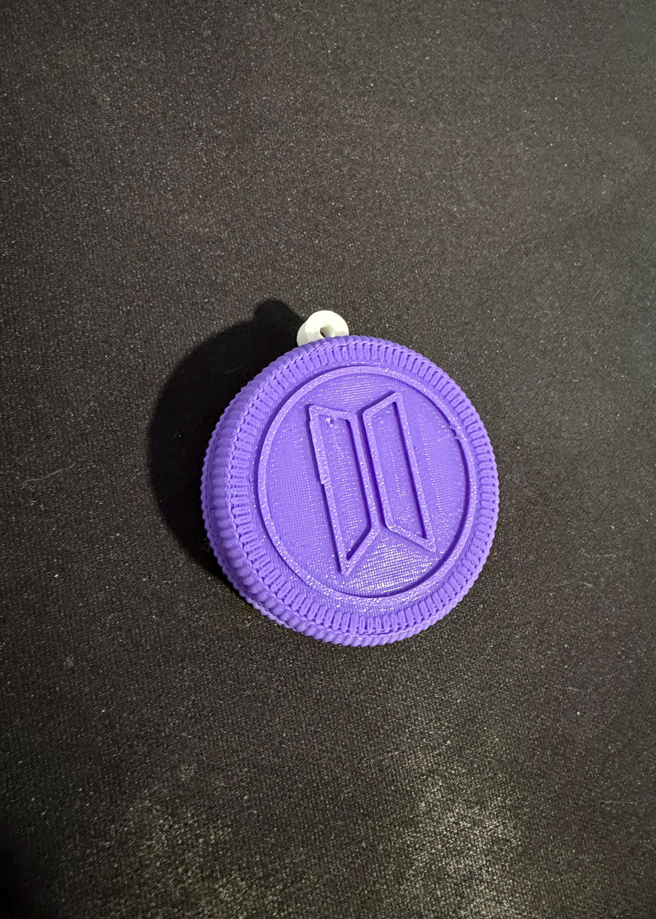Cookie charm hanging from a backpack zipper
