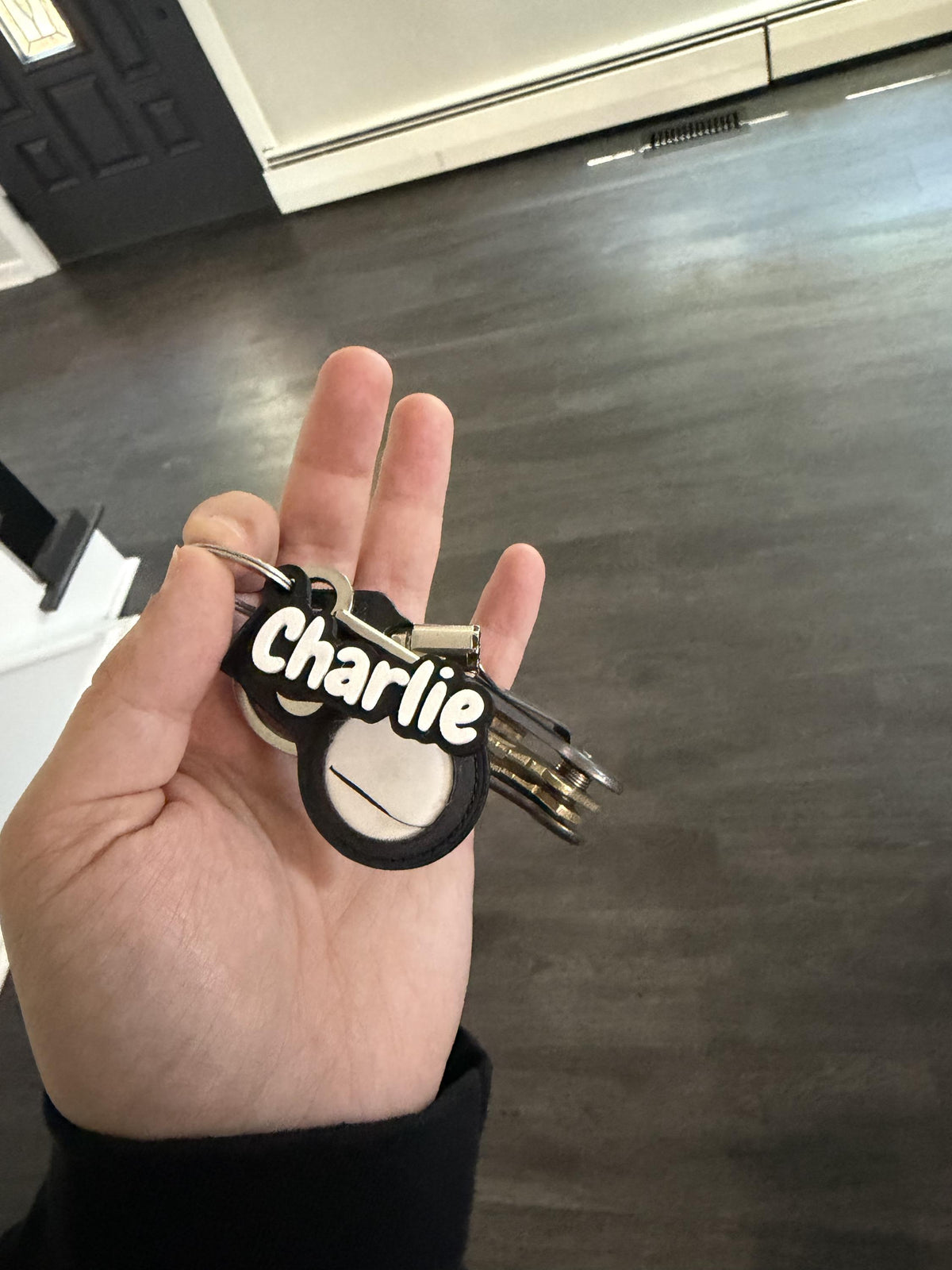 Close-up of raised two-color letters on a 3D printed name tag